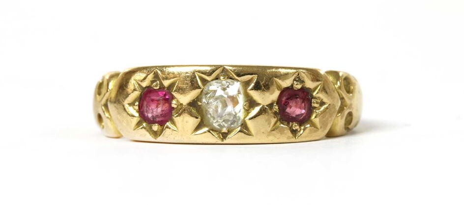 A gold diamond and ruby three stone ring