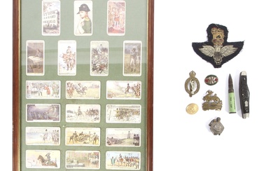 A group of militaria collectables. Including a Royal Berkshire cap badge, Royal Corps of Signals, a penknife, framed John Player cigarette cards depicting Napoleon, etc
