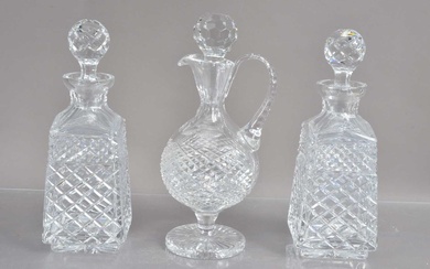 A high quality lead crystal claret jug and a pair of cut crystal whisky or liqueur decanters