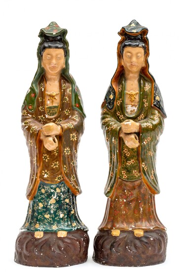 A large pair of white faience cold painted Guanyin figures