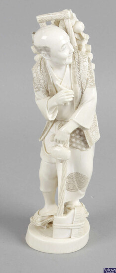 A late 19th century ivory okimono modelled as an elderly gentleman.