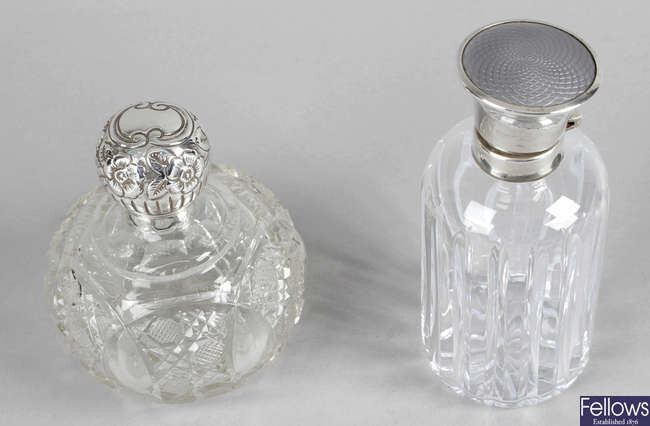 A late Victorian silver mounted globular glass perfume bottle, together with a modern fluted glass example with silver mounted & enamel lid. (2).