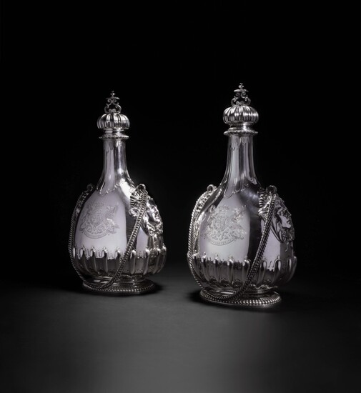 A matched pair of massive Victorian silver pilgrim bottles and covers , one John Bodman Carrington for Carrington & Co., 1892, the other Sebastian Garrard for R. & S. Garrard & Co., 1901, both London