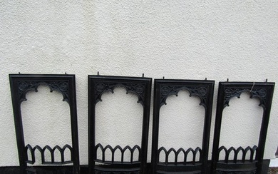A matched set of four gothic 19th century cast iron fire pla...