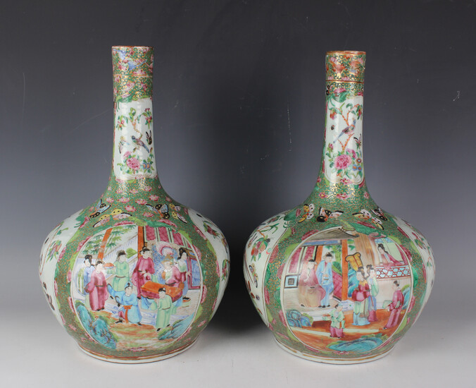 A pair of Chinese Canton famille rose porcelain bottle vases, mid-19th century, each typically paint
