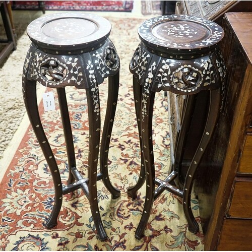 A pair of Chinese mother of pearl inset hardwood vase stands...