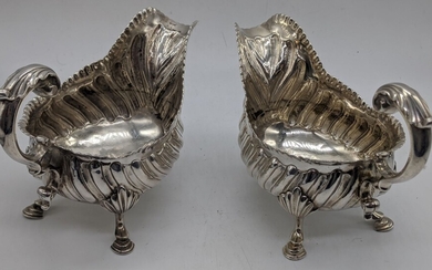 A pair of George III silver sauce boats, embossed...