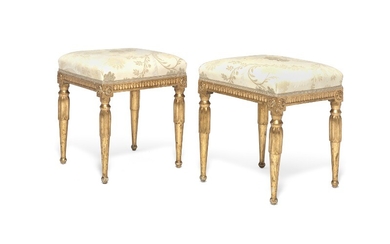 A pair of Gustavian giltwood stools with carved borders and rosettes, round fluted legs. Sweden, late 18th century. (2)