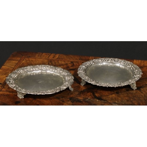A pair of Portuguese silver shaped circular card waiters of ...