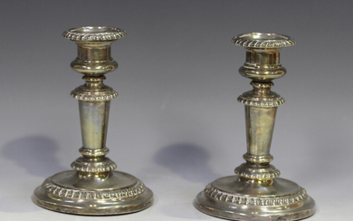 A pair of William IV silver candlesticks, each with gadrooned detachable nozzle, on a tapered stem w