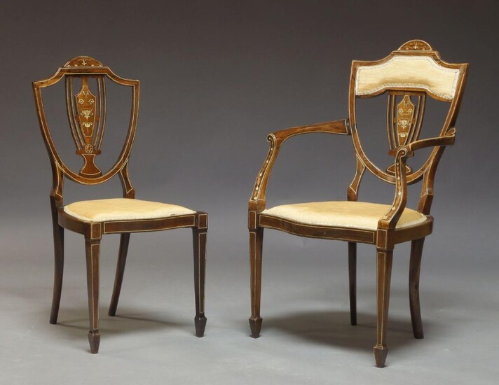 A pair of carved oak high back hall chairs, late 17th century, with carved scroll crest above caned panel flanked by turned columns above caned seat a carved scroll rail raised on cabriole front legs