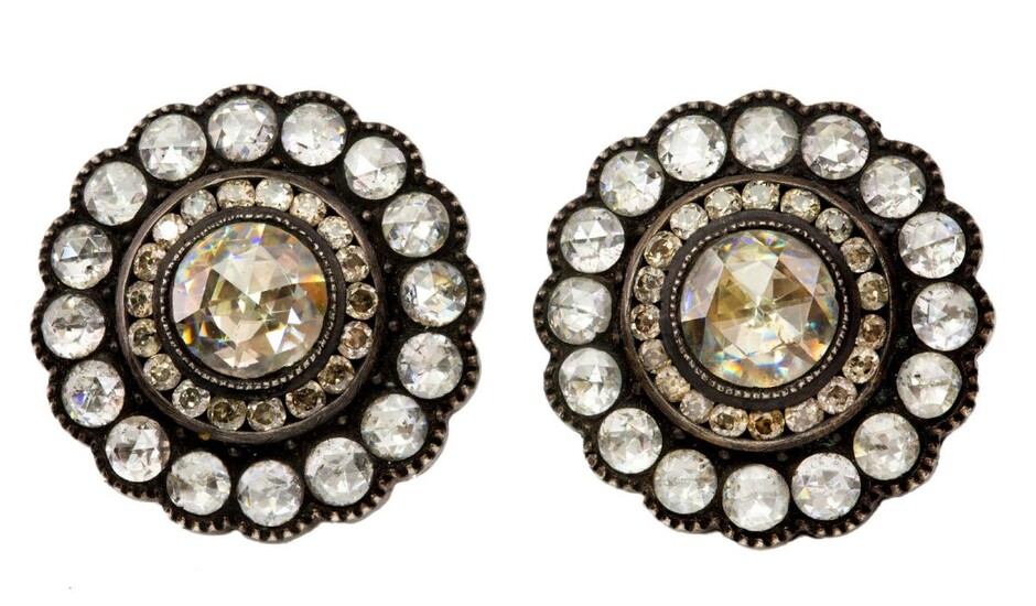 A pair of diamond earrings, each of cluster design set with rose-cut diamonds accented with circular-cut stones, the reverse with foliate engraved decoration, post fittings.