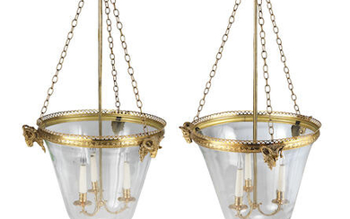 A pair of gilt brass three light hall lanterns