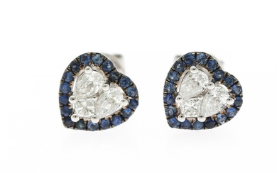 A pair of heart shaped sapphire and diamond ear studs each set with numerous circular-cut sapphires and three diamonds, mounted in 18k white gold. (3)