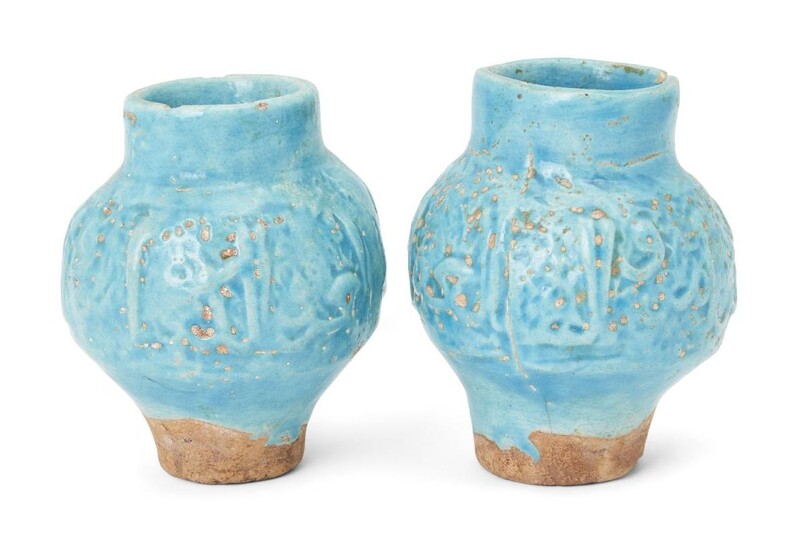 A pair of inscribed moulded Kashan turquoise glazed pottery vases, Iran, 13th century, of baluster form, 12.9cm. high (2) Provenance: Private collection London since 1968