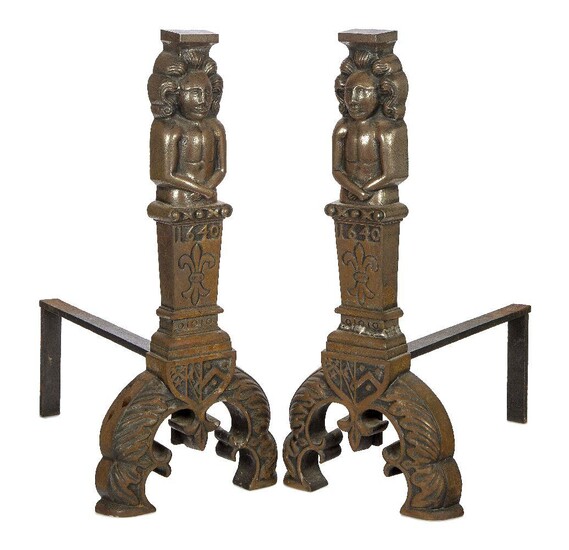 A pair of large cast iron fire dogs, 17th century style, the uprights each cast with a figural top, each with plinths featuring a fleur-de-lis ornament and bearing date '1640', to twin splayed feet modelled as laurels surmounted with heraldic crest...