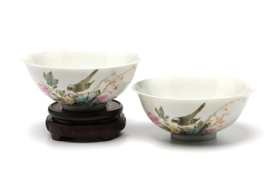 A pair of polychrome porcelain bowls painted with birds in flight among flowers pattern