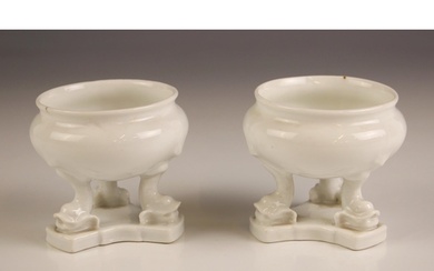 A pair of white glazed continental porcelain table salts, 19...