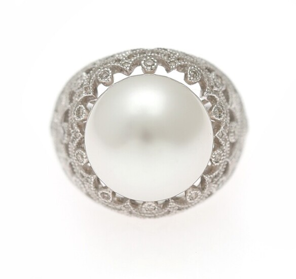 NOT SOLD. A pearl and diamond ring set with a cultured pearl encircled by numerous...