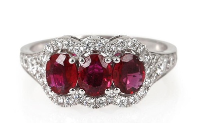 A ruby and diamond ring set with three oval-cut rubies weighing a...