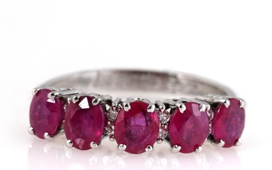A ruby ring set with five oval-cut rubies weighing a total of...