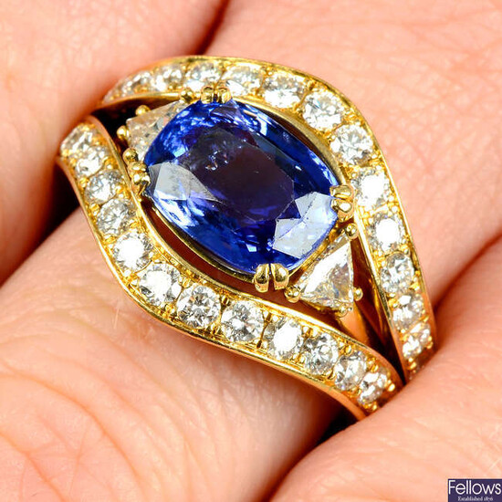 A sapphire and triangular-shape diamond ring with brilliant-cut diamond jacket ring.