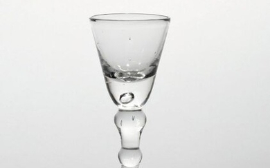 A small baluster wine glass c.1740, the rounded funnel bowl...