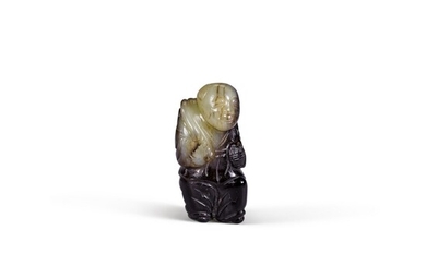 A small celadon and black jade figure of a boy holding a lotus Ming dynasty | 明 青玉持蓮童子