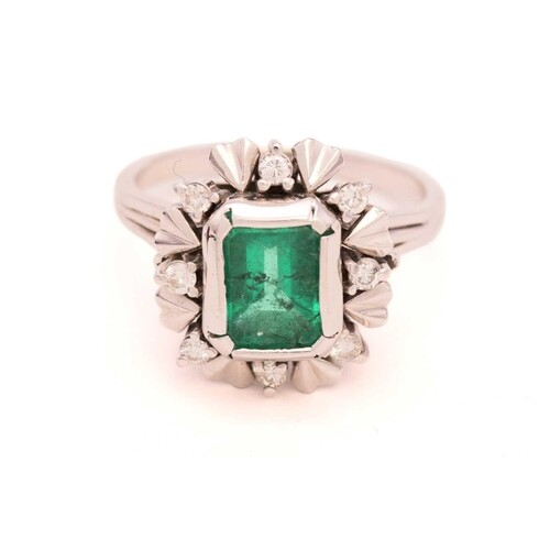 A synthetic emerald cocktail ring, centred with a step-cut s...