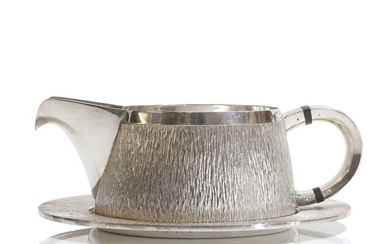 ▲ A textured sterling silver cream jug