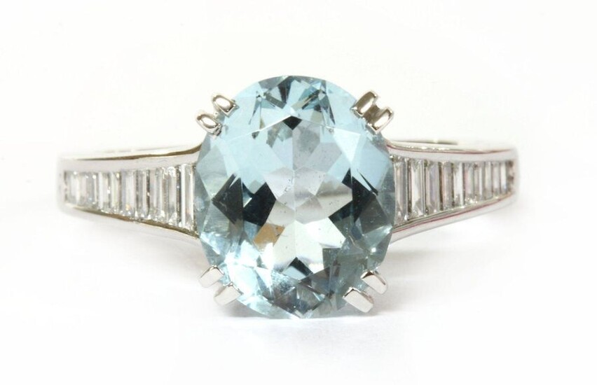 A white gold aquamarine and diamond ring, an oval mixed...