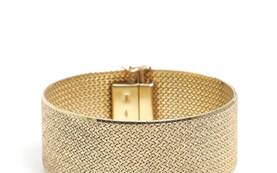 A wide 14k gold bracelet. L. 19.1. W. 2.4 cm. Weight app....