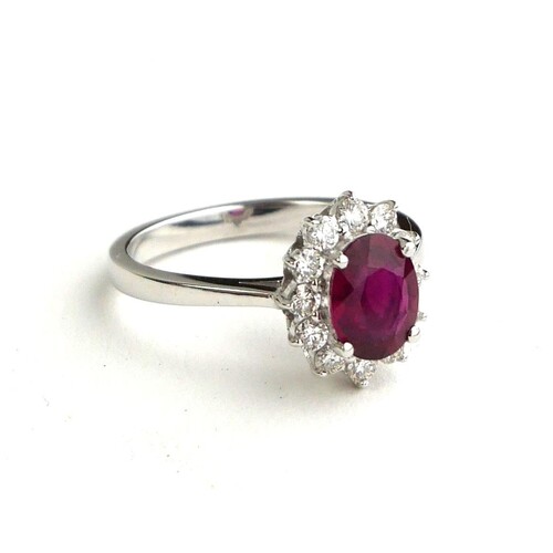 AN 18CT WHITE GOLD, OVAL CUT RUBY AND DIAMOND RING (SIZE N/O...