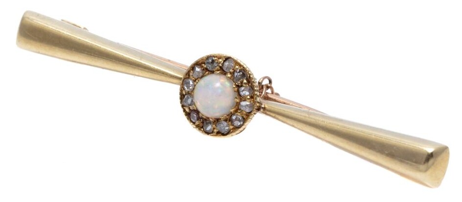 AN ANTIQUE 15CT GOLD OPAL AND DIAMOND BAR BROOCH; tapering bar centring a cluster of a cobochon crystal opal surrounded by 11 rose c...