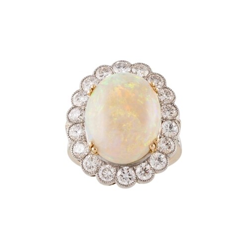 AN OPAL AND DIAMOND CLUSTER RING, the cabachon opal to a bri...