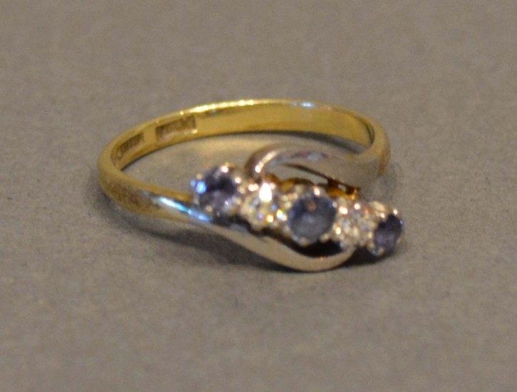 An 18 Carat Gold Sapphire and Diamond Crossover Ring set wit...