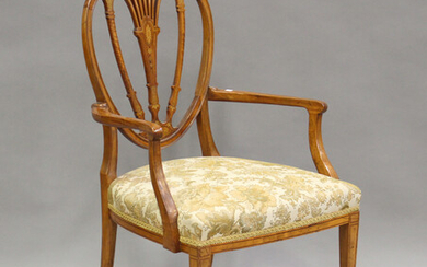 An Edwardian Irish satinwood pierced splat back elbow chair with inlaid decoration, the overstuffed