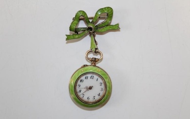An Edwardian green enamel gilt silver ladies brooch watch. The...