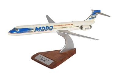 An aircraft manufacturers desk top model of a McDonnell Douglas MD90 passenger plane