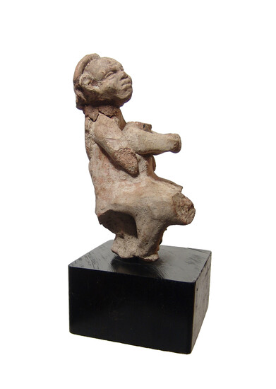 An ancient terracotta figure of a mother with child