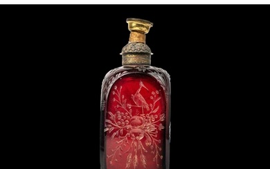 An early 18th century ruby glass decanter, etched with exoti...