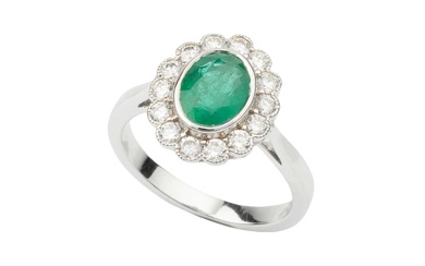 An emerald and diamond dress ring, the oval cut emerald...