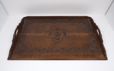 An oak Arts and Crafts style tray, with stepped handle...