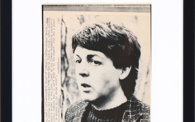 An original American black-and-white wire photo of Paul McCartney outside his Sussex home in the moment he's told that John Lennon has been killed. 1980.