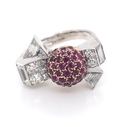 Diamond and ruby cocktail ring in a bow design. Central ball...