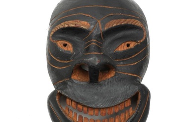 Greenlandic carved and patinated wood spirit mask with carved teeth. 20th century....