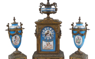 JAPY FRERES SEVRES STYLE PORCELAIN MOUNTED GILT-BRASS THREE-PIECE CLOCK GARNITURE, LATE 19TH CENTURY Height of clock: 19 1/2 in. (49.5 cm.), Height of urns: 14 in. (35.6 cm.)