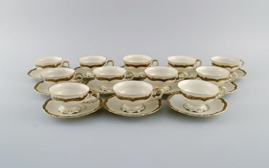 KPM, Berlin. Twelve Royal Ivory tea cups with saucers in cream-colored porcelain with gold