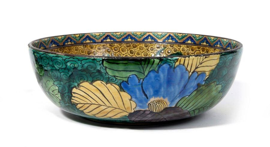 Large Kutani bowl, inside decorated with two shishi lions playing on a background of Japanese apricot blossoms; the outside decorated with peonies on a background of green clouds. Mark underneath : Fuku. In a box. Meiji period.