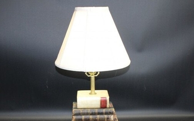 Stacked leather bound books desk lamp